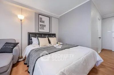 Modern bedroom with stylish decor and cozy ambiance, featuring a comfortable bed and elegant lighting.