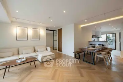 Spacious modern living room with elegant dining area and open kitchen layout.