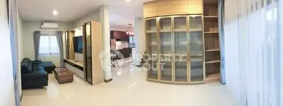 Spacious living room with modern furniture and large windows for natural light.