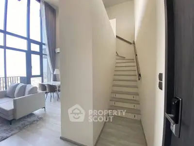 Modern duplex apartment with high ceilings and large windows