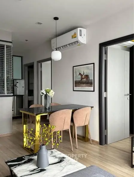Modern dining area with stylish decor and air conditioning in a cozy apartment.