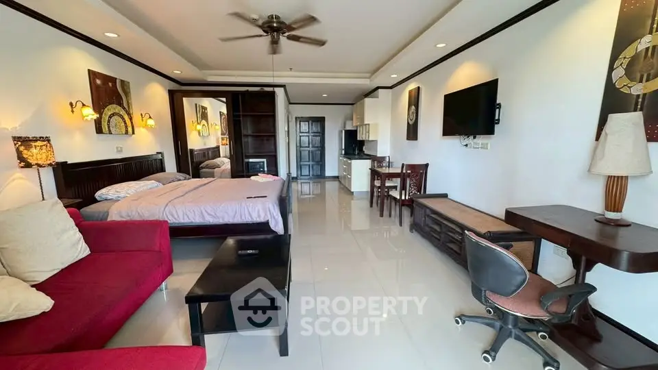 Spacious studio apartment with modern furnishings and open layout, featuring a cozy bed and stylish decor.