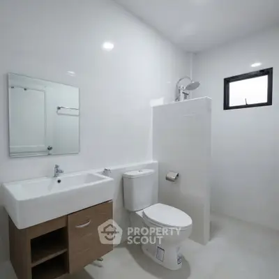 Modern minimalist bathroom with sleek fixtures and natural light.