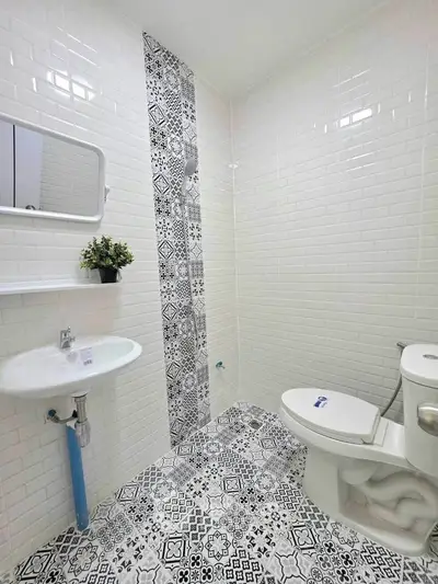 Stylish bathroom with patterned tiles and modern fixtures