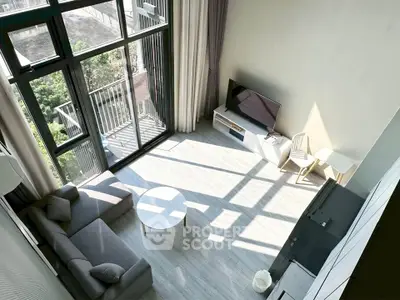 Spacious modern living room with large windows and balcony view