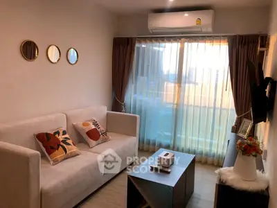 Cozy living room with modern decor and large window for natural light.