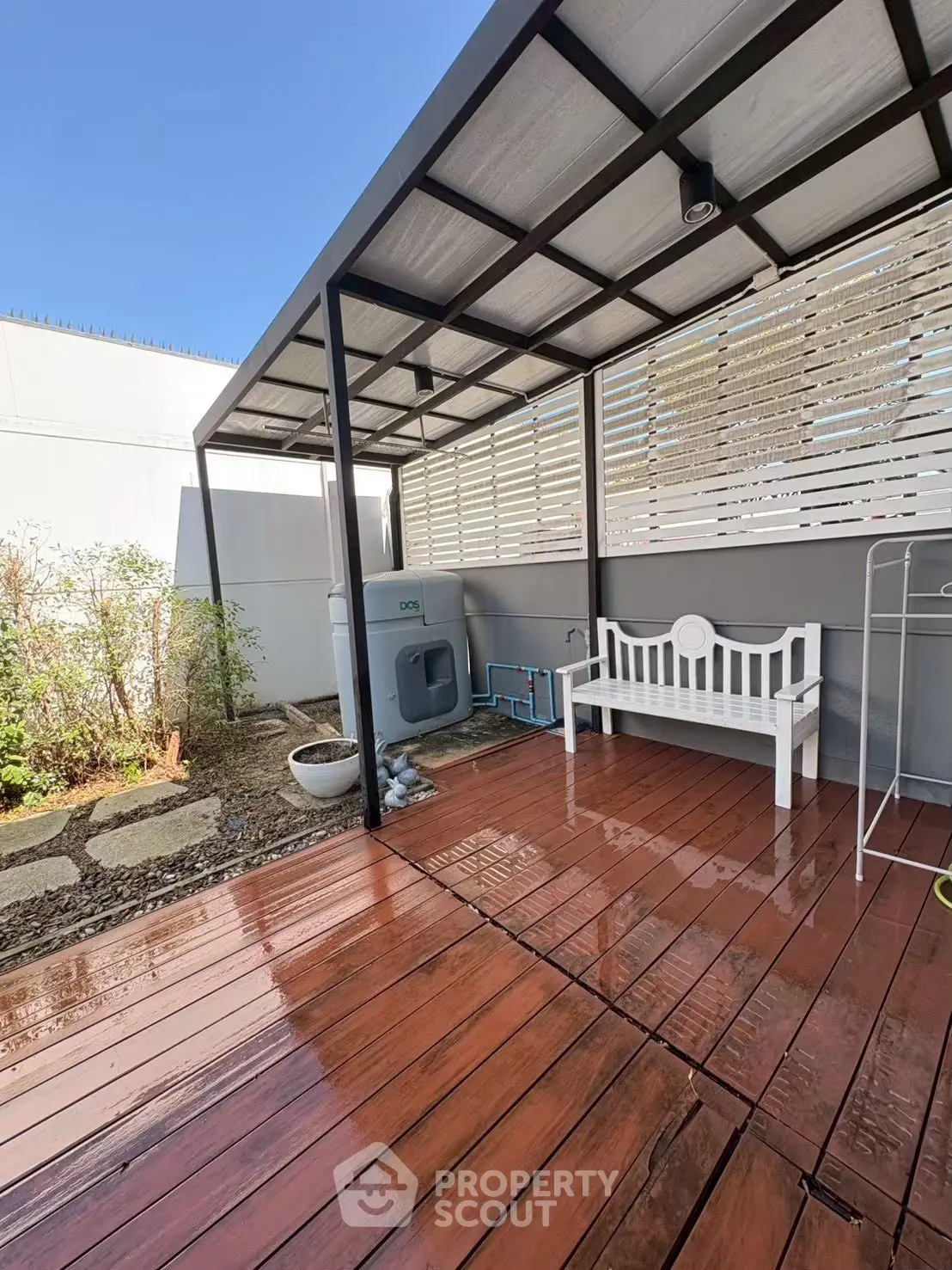 Charming outdoor patio with wooden deck and stylish seating area, perfect for relaxation and entertaining.