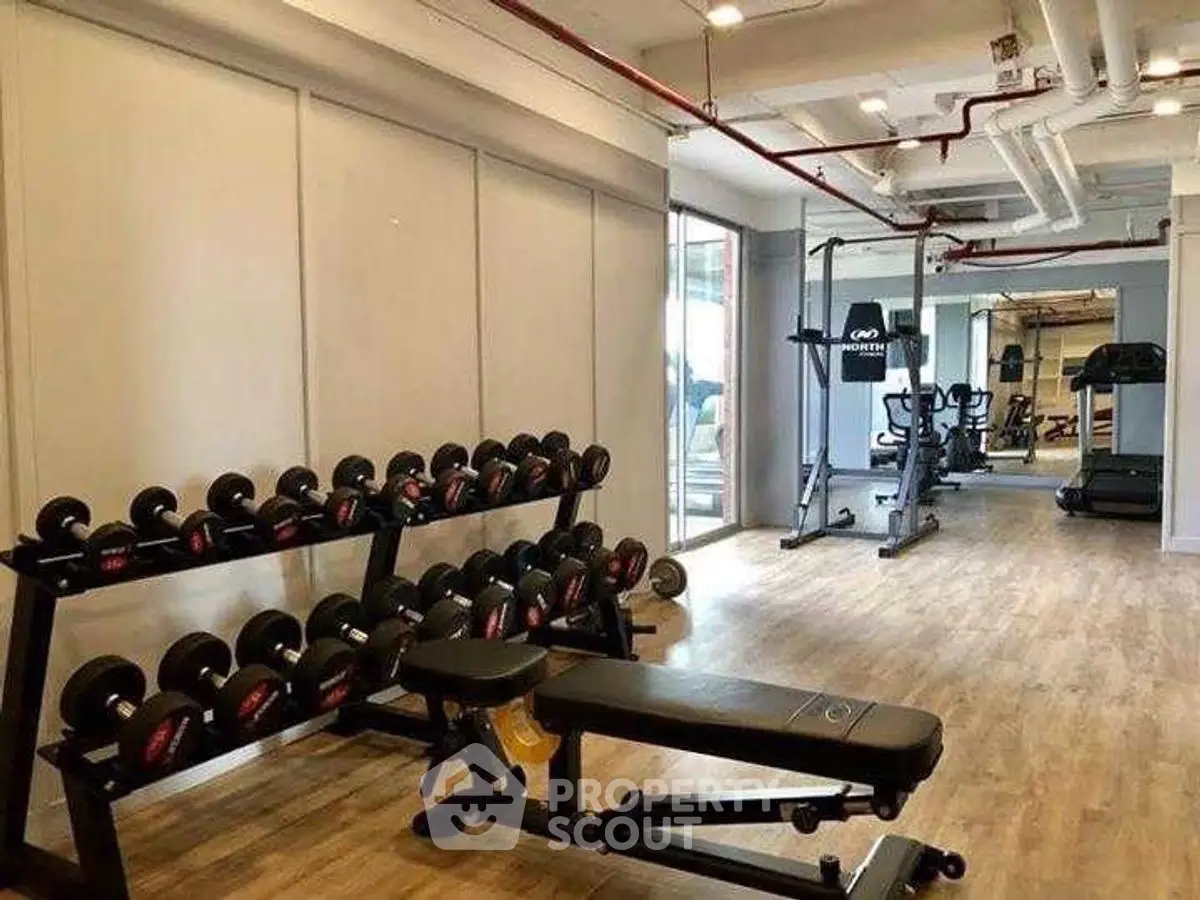 Modern gym with state-of-the-art equipment in luxury apartment complex