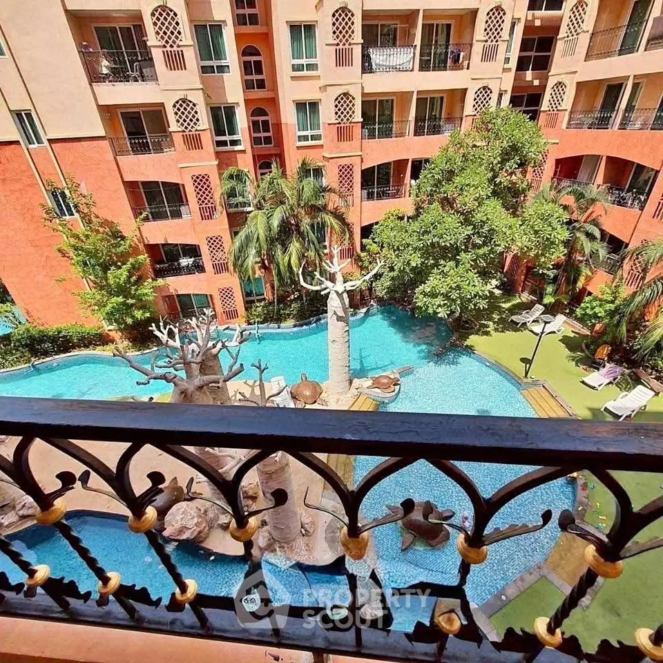 Stunning view of a luxurious apartment complex with a unique pool and lush greenery.