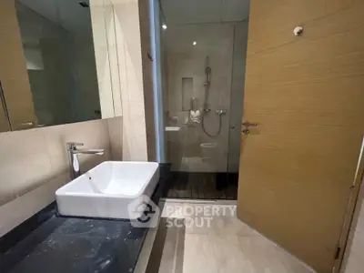 Modern bathroom with sleek sink and glass shower enclosure