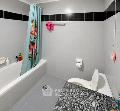 Spacious bathroom with modern fixtures and floral shower curtain