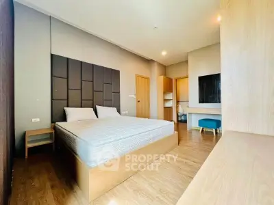 Spacious modern bedroom with wooden flooring and stylish decor