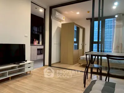Modern apartment interior with open layout, featuring a cozy living area and stylish kitchen.