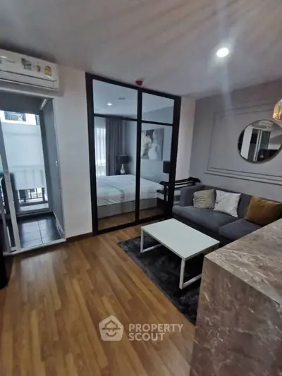 Modern living room with cozy sofa and bedroom view