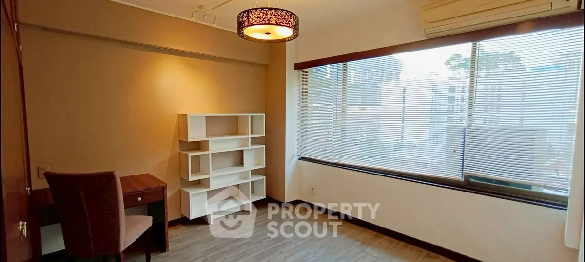 Bright study room with large window and modern furnishings