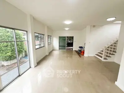 Spacious modern living room with large windows and garden view
