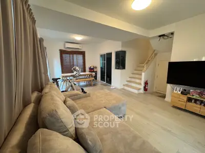 Spacious living room with modern decor and cozy seating area