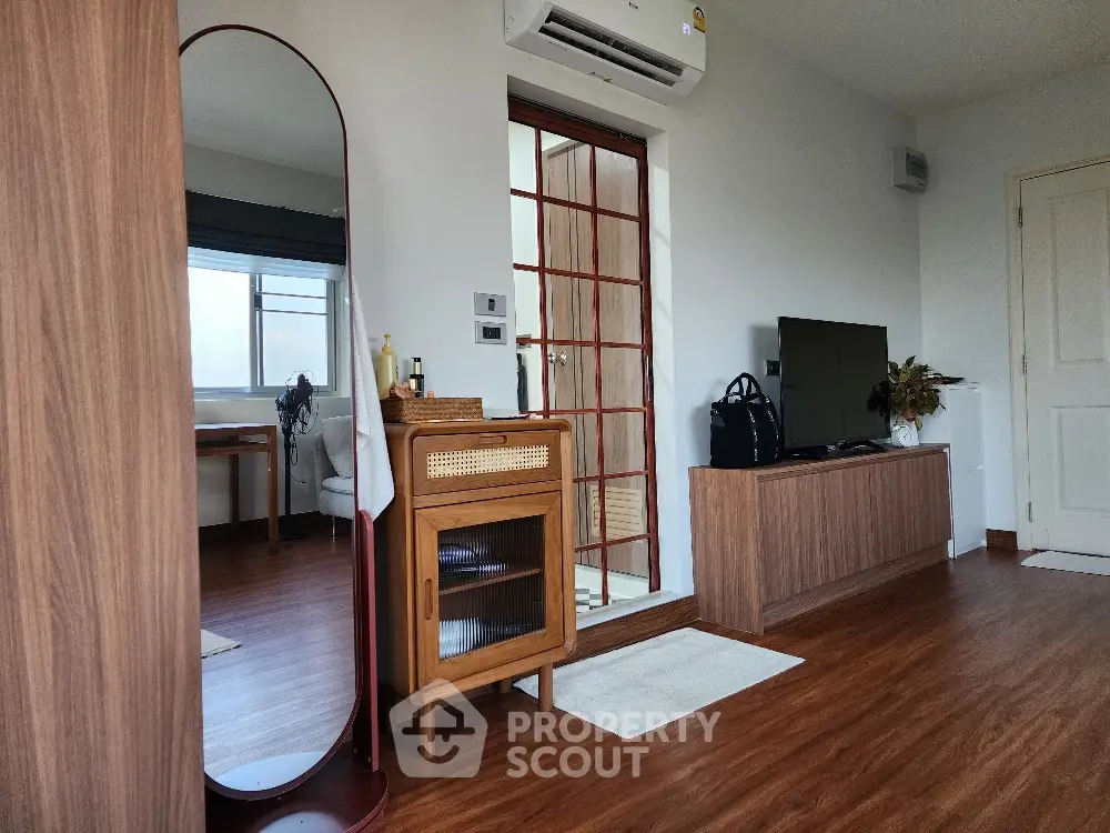 Modern living room with stylish wooden furniture and large mirror