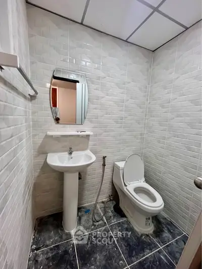 Modern bathroom with white tiles and pedestal sink