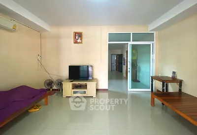 Spacious living room with modern decor and ample natural light, perfect for relaxation and entertainment.