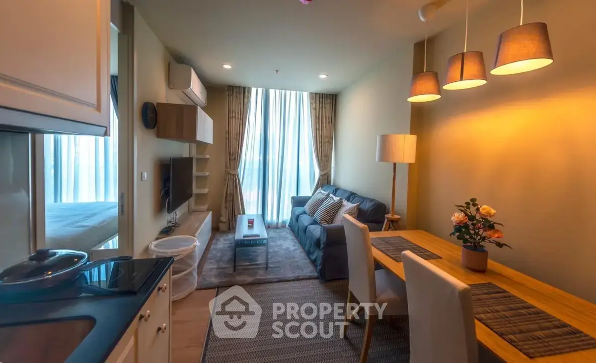 Cozy modern living room with dining area and stylish lighting in a contemporary apartment.