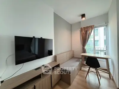 Modern living room with wall-mounted TV and cozy seating area