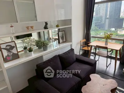Stylish living room with modern decor and city view, featuring cozy seating and elegant shelving.