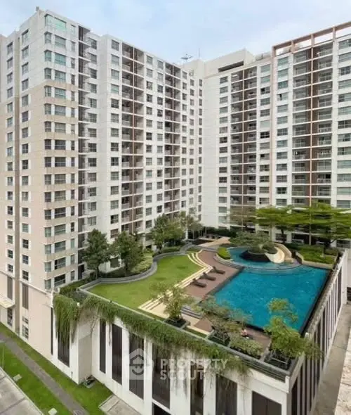 Luxurious high-rise building with rooftop pool and garden, offering stunning city views and modern amenities.