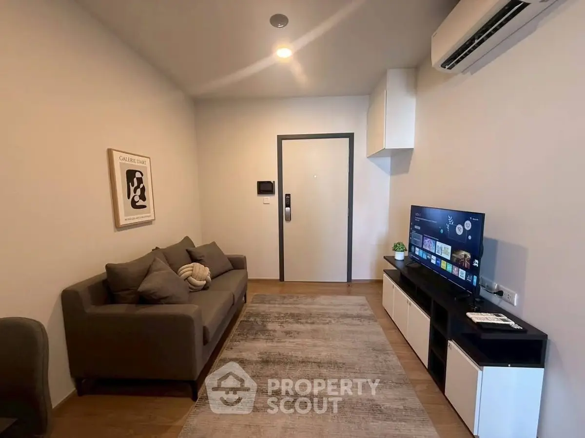 Modern living room with sleek furniture and wall-mounted TV, perfect for cozy relaxation.