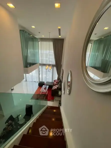 Luxurious modern living room with high ceilings and elegant staircase