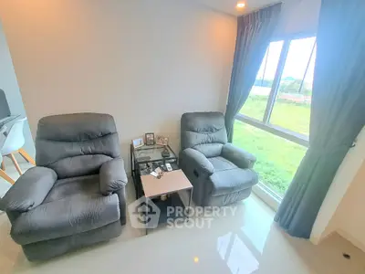 Cozy living room with plush armchairs and scenic window view