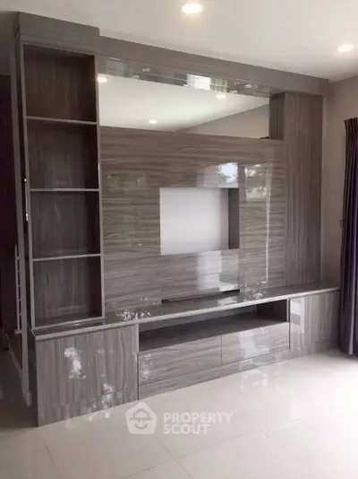 Modern living room with sleek built-in entertainment center and glossy finish