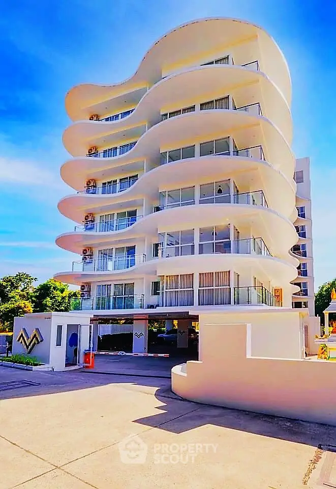 Stunning modern building with unique curved architecture and spacious balconies.