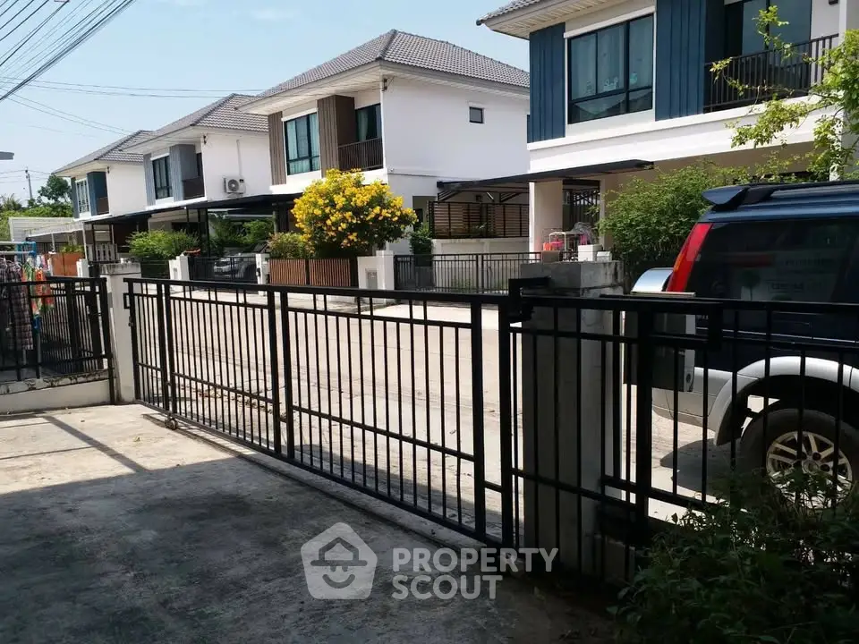 Charming suburban neighborhood with modern houses and gated driveway