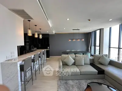 Luxurious open-plan living room with modern kitchen and panoramic city views.