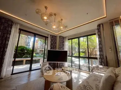 Luxurious living room with modern decor and large windows overlooking a lush garden view.