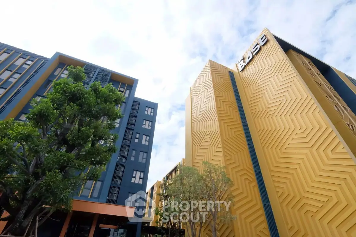Modern architectural building with unique geometric facade and lush greenery