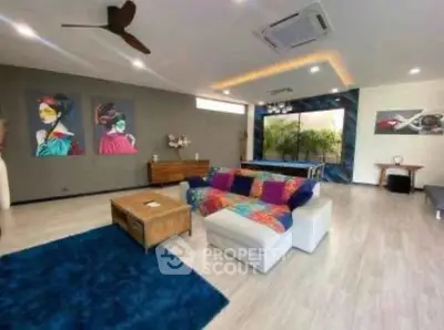 Spacious modern living room with colorful decor and stylish ceiling fan