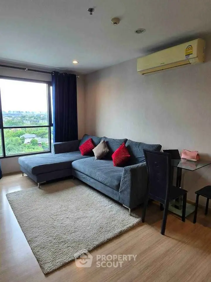Modern living room with large window and stylish furniture in a cozy apartment.
