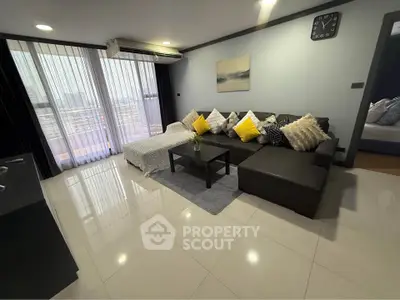 Modern living room with stylish decor and large windows for natural light.