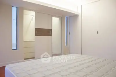 Spacious bedroom with modern closet and natural light