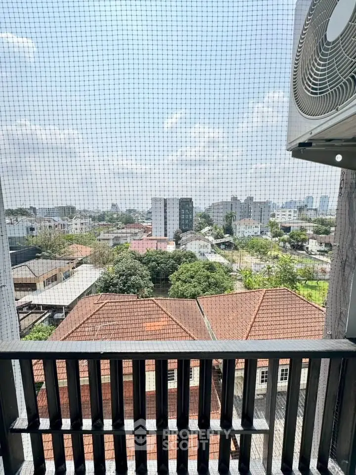 Stunning cityscape view from a high-rise balcony with air conditioning unit.