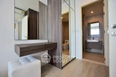 Modern interior with sleek bathroom and mirrored closet in stylish apartment
