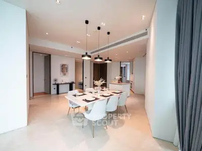 Luxurious open-plan dining area with modern decor and elegant lighting in a high-end apartment.