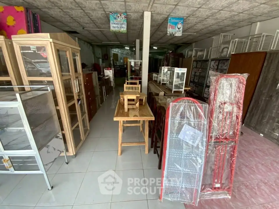 Spacious furniture store interior showcasing diverse wooden and metal furniture pieces.