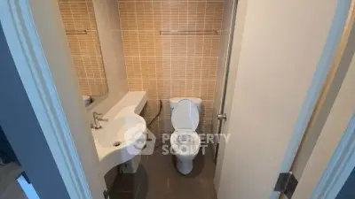 Compact bathroom with modern fixtures and stylish tile design
