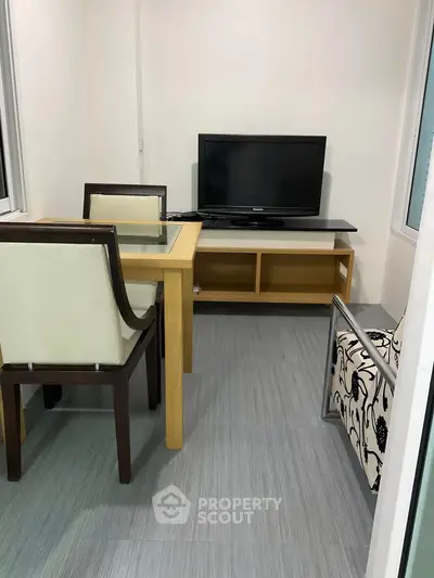 Cozy small living room with modern furniture and TV setup