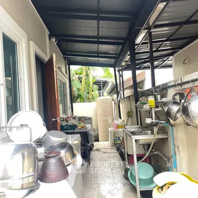 Spacious outdoor kitchen area with ample storage and modern appliances, perfect for culinary enthusiasts.