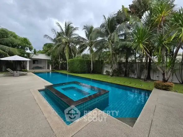 Luxurious tropical poolside oasis with lush greenery and modern design