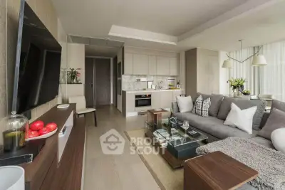 Modern living room with open kitchen, stylish decor, and cozy seating area in a contemporary apartment.